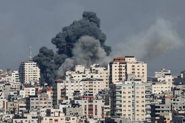 Smoke rises above high rise buildings in Gaza following retaliatory strikes by Israel.