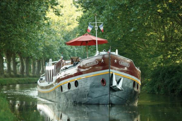A Belmond barge in the French countryside.